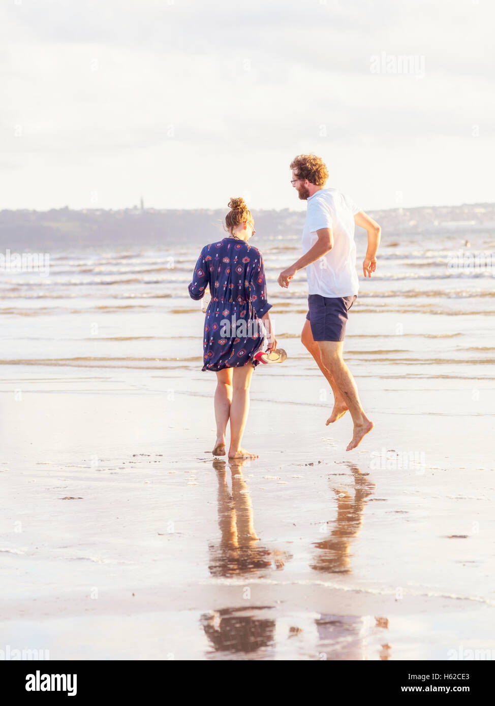 Couple talking a beach walk Stock Photo
