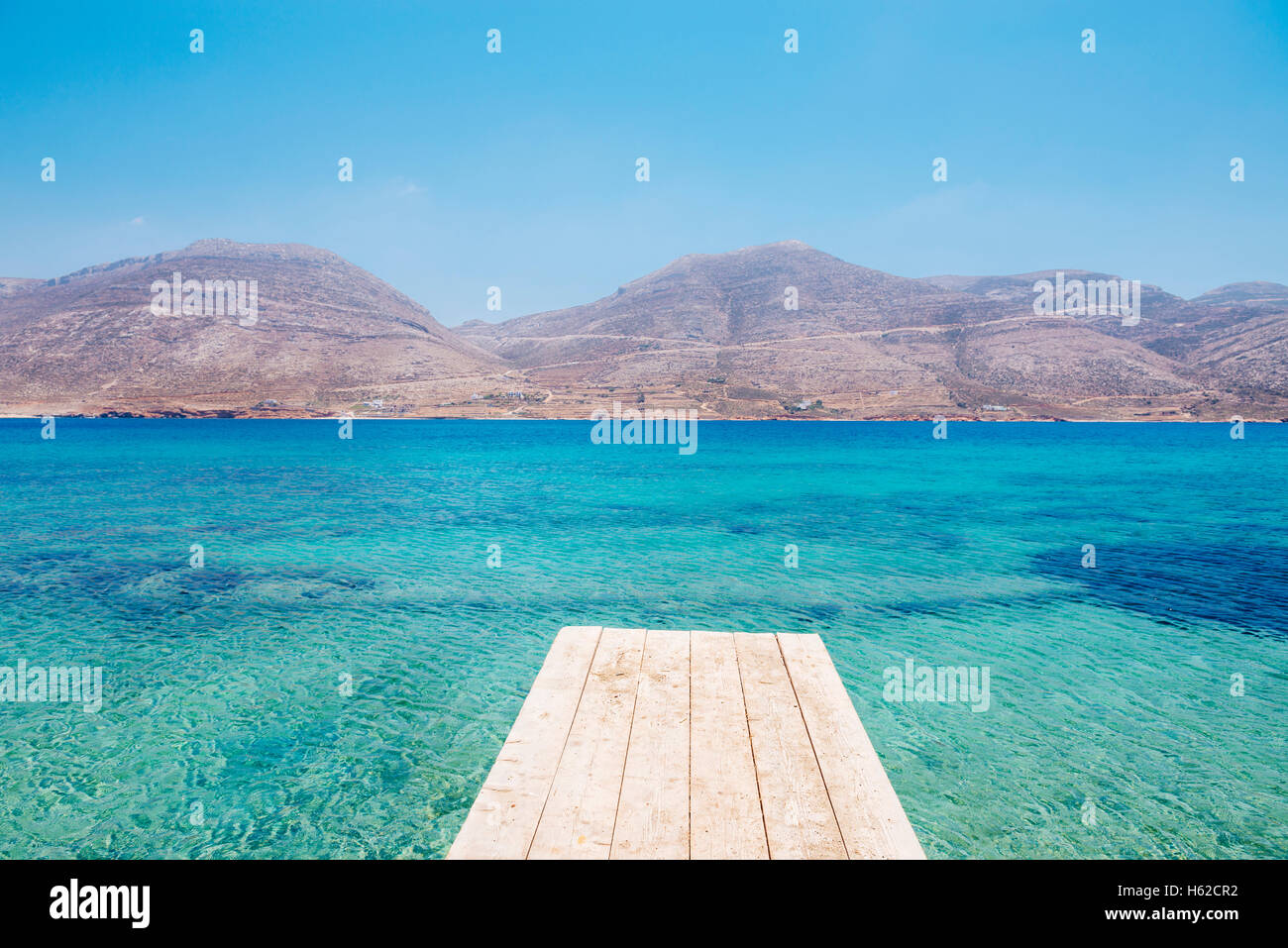 Greece, Cyclades, Amorgos, Nikouria island, wooden jetty and Aegean Sea Stock Photo