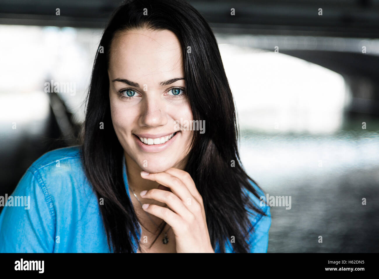 Portrait of smiling young woman with brown hair Stock Photo - Alamy