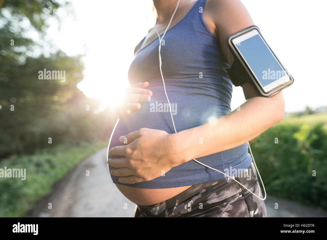 Pregnant woman taking a break from jogging Stock Photo Alamy