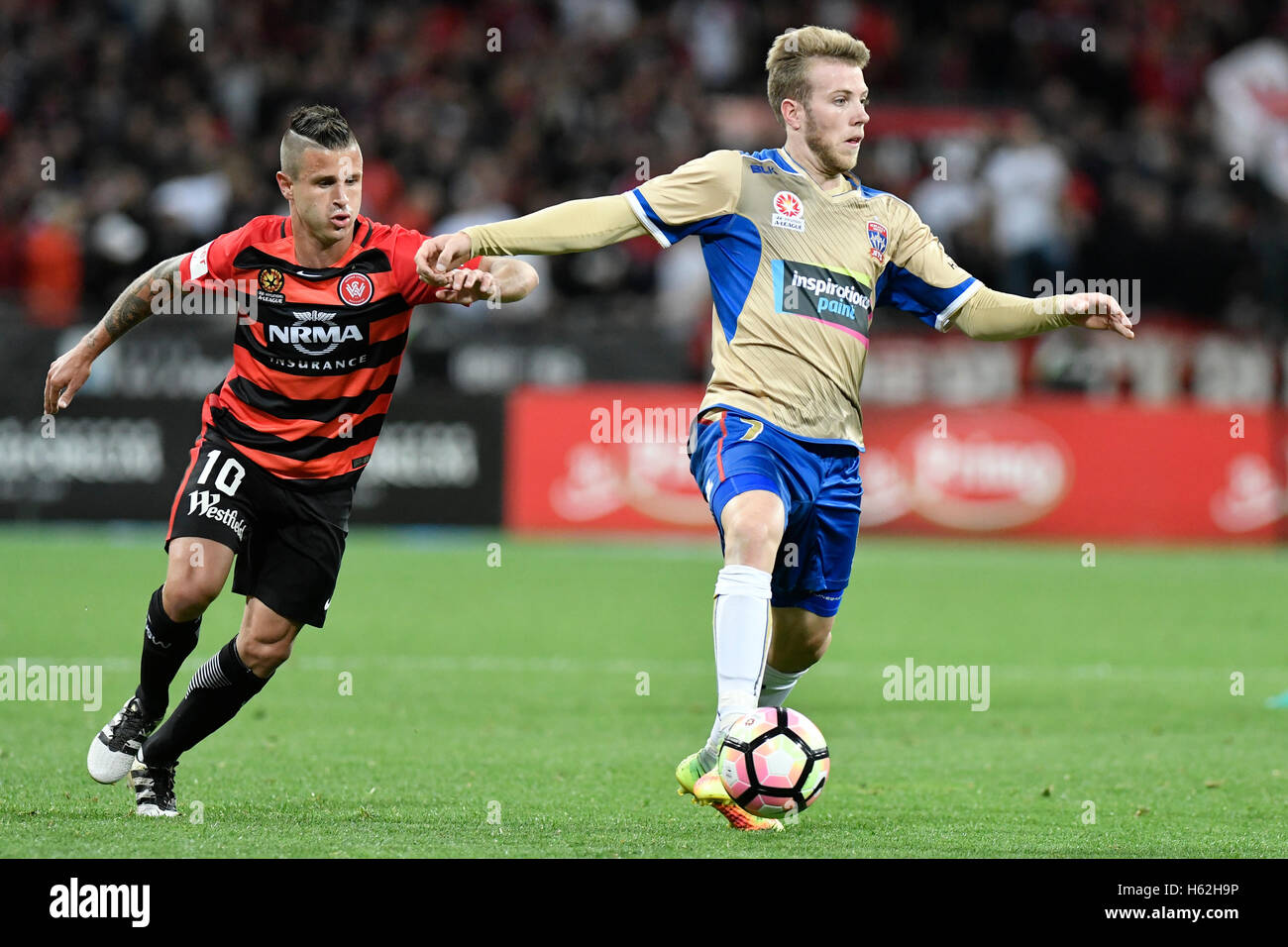 Spotless Stadium, Sydney, Australia. 23rd Oct, 2016. Hyundai A-League Football. Western Sydney Wanderers versus Newcastle Jets. Jets midfielder Andrew Hoole is chased down by Wanderers midfielder Nicolas Martine. The game ended in a 2-2 draw. Credit:  Action Plus Sports/Alamy Live News Stock Photo