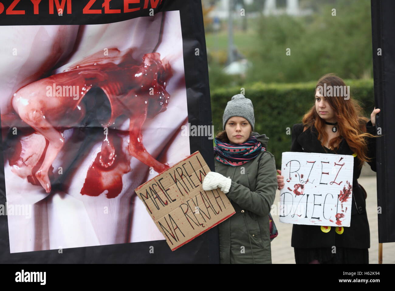 Gdynia, Poland. 23rd Oct, 2016. Pro-life organisation protest in Gdynia. Participants demand full ban on abortion in Poland. They hold banners with dead fetuses, and with portrait of Law and Justice (PiS) party leader Jaroslaw Kaczynski to show that during his reign 950 children were killed (in sense there was 950 legal abortions in Poland during last year). Credit:  Michal Fludra/Alamy Live News Stock Photo