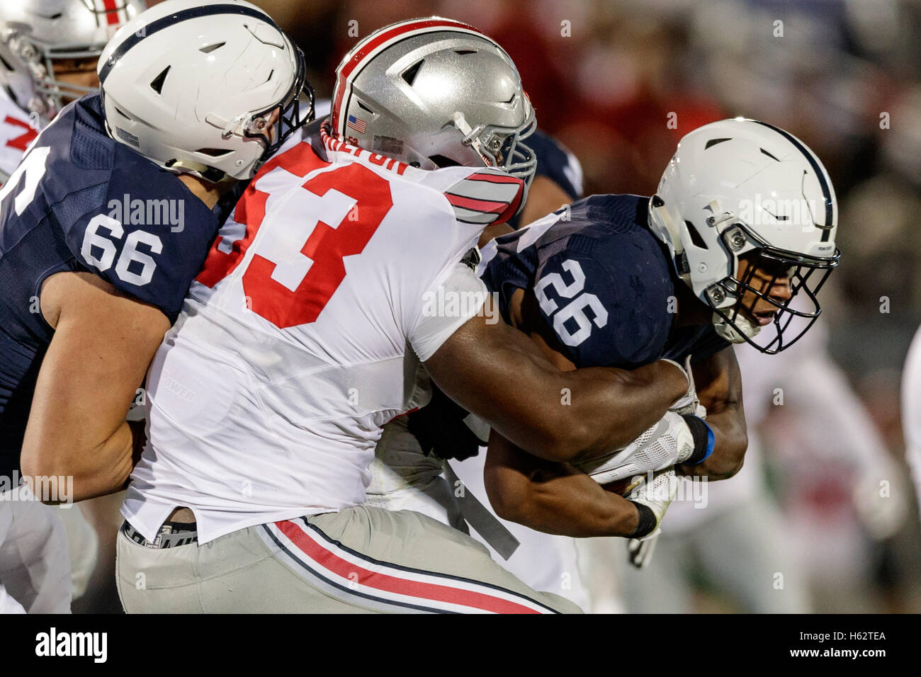 October 21, 2016 - University Park, Pennsylvania, USA - October 22nd, 2016: Ohio State Buckeyes defensive tackle Davon Hamilton (53) tackles Penn State Nittany Lions running back Saquon Barkley (26) during NCAA football game action between the Ohio State Buckeyes and the Penn State Nittany Lions at Beaver Stadium, University Park, PA. Photo by Adam Lacy/Zuma Wire (Credit Image: © Adam Lacy via ZUMA Wire) Stock Photo