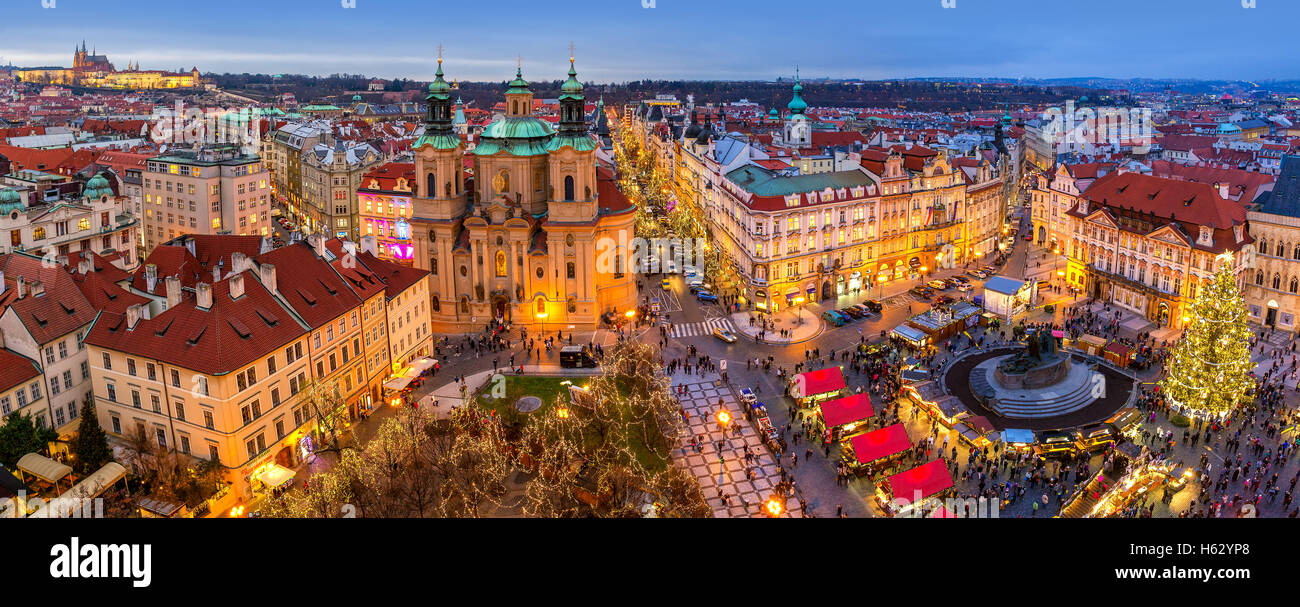 Panoramic view from above of city skyline, illuminated buildings and traditional Christmas market in Prague. Stock Photo