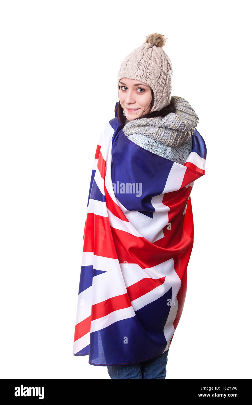 Learn English. Beautiful student holding books. Young woman standing with the UK flag in the background looking up. Stock Photo