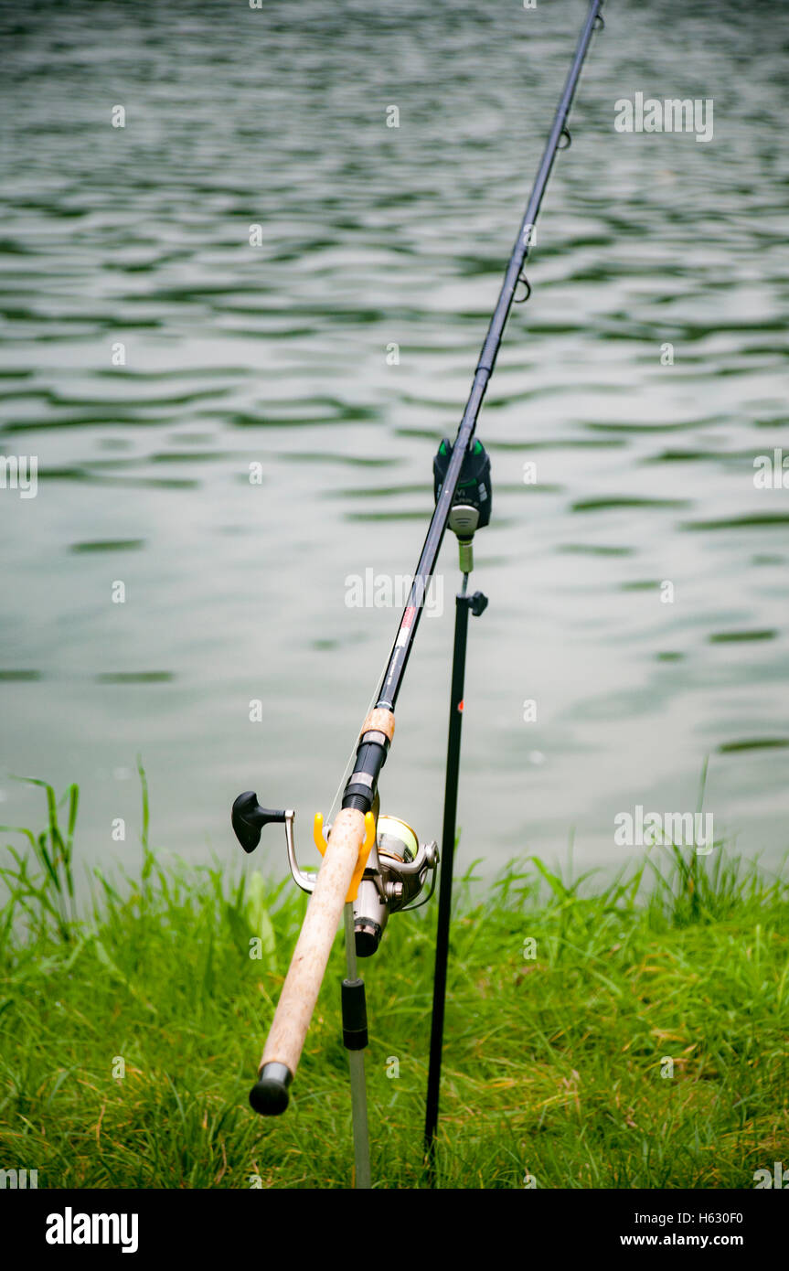baited Fishing rod on a river bank Stock Photo