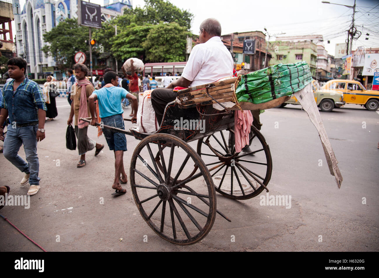 traditional hand pulled rickshaw puller pulling with passenger on ...