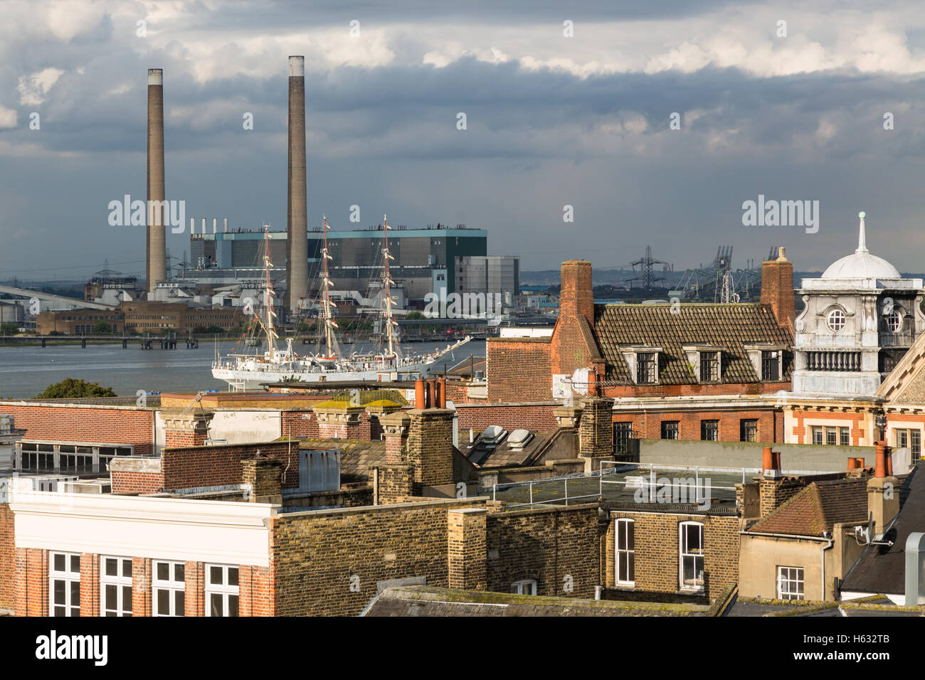 Image of Gravesend town centre roof tops as a tall ship sails by Stock Photo