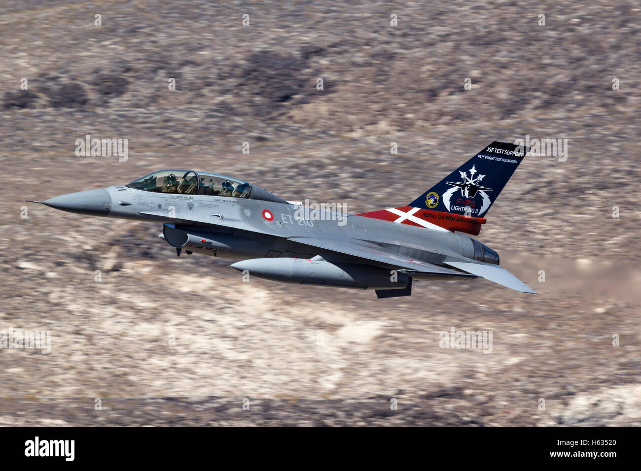 Royal Danish Air Force F-16 in low level flight over California's Mojave Desert. Stock Photo