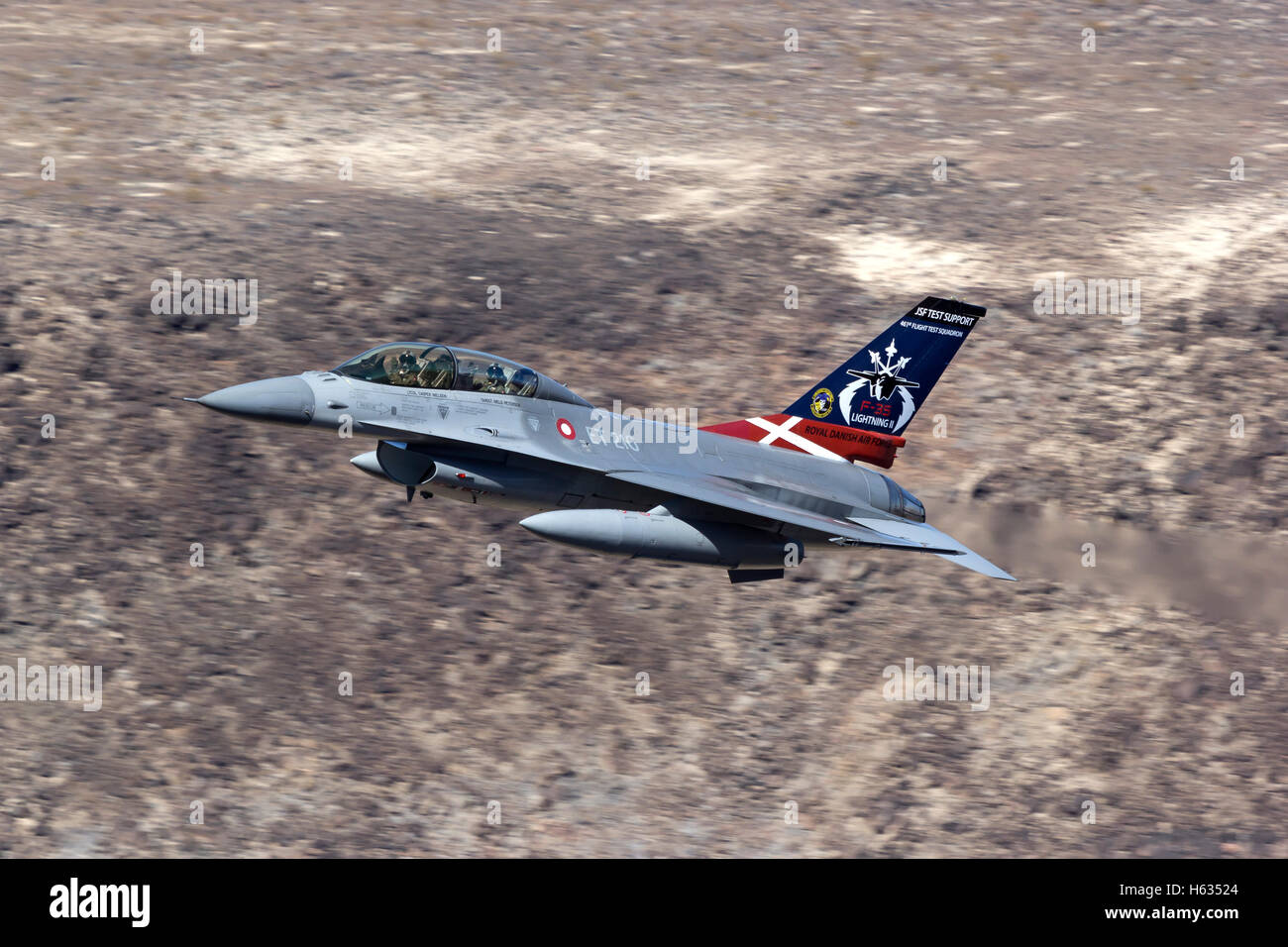 Royal Danish Air Force F-16 in low level flight over California's Mojave Desert. Stock Photo