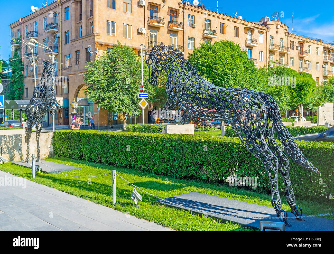 The impressive sculpture of two horses, made of horseshoes, in motin, lcated in Cafesjian sculpture garden, Yerevan Stock Photo