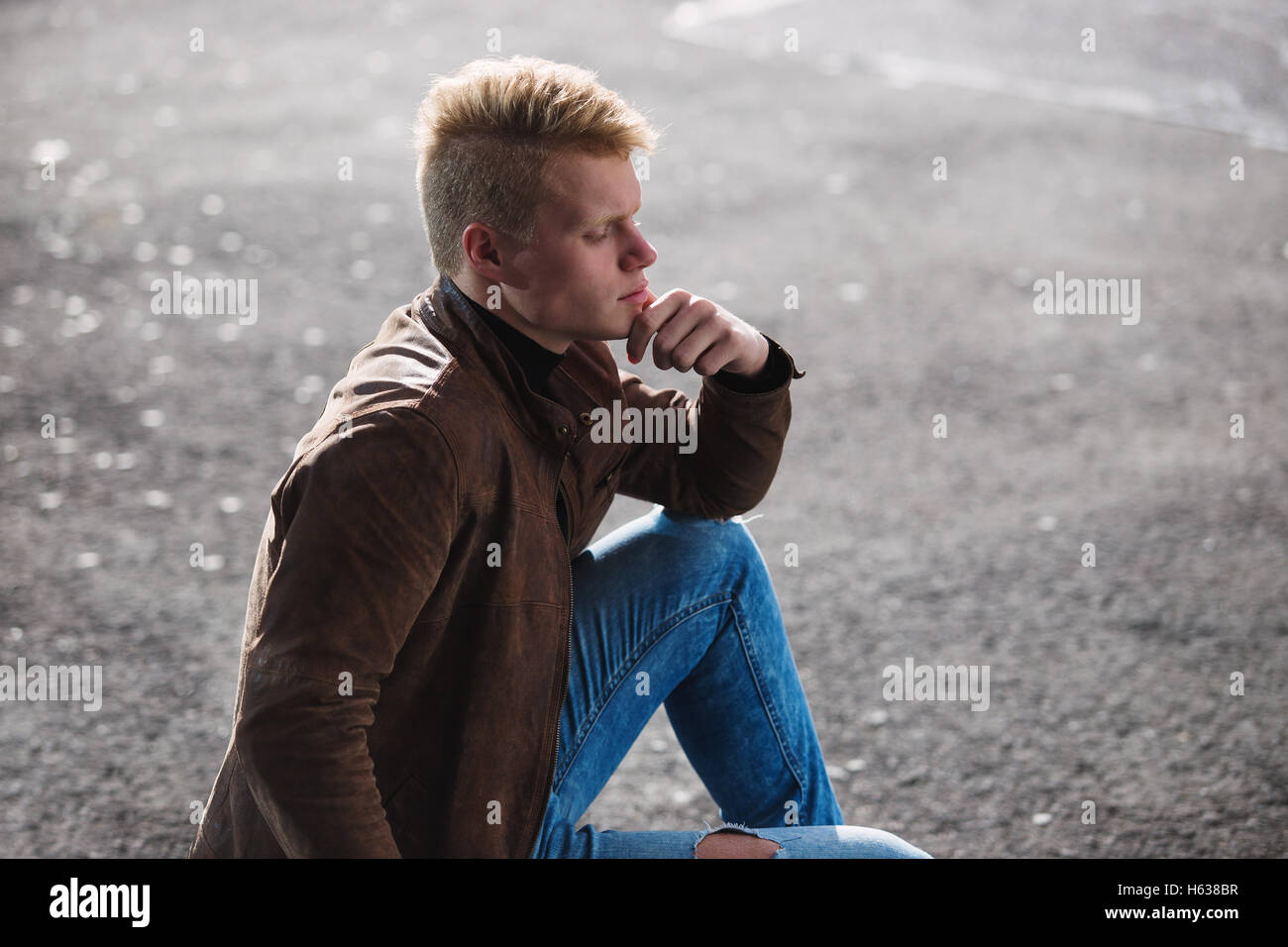 Young handsome stylish man in brown jacket in autumn time outdoor in casual style Stock Photo