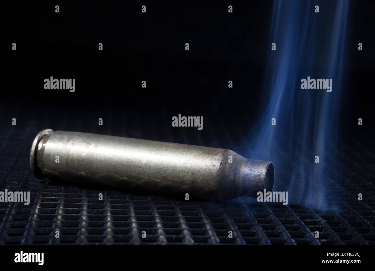 Rifle cartridge that is empty but pouring out smoke Stock Photo Alamy