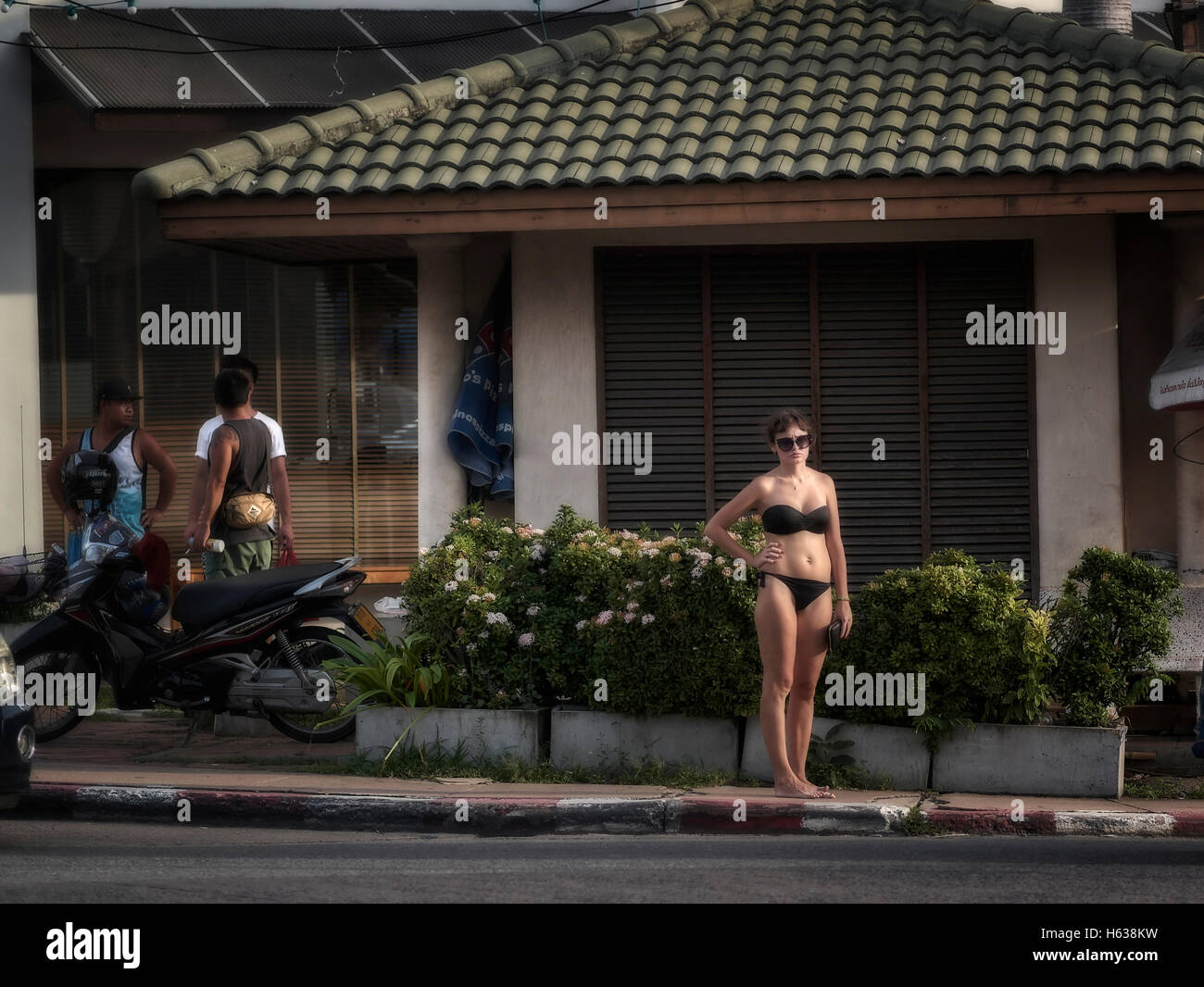 Bikini street. Fashion faux pas of bikini clad woman in the street. Pattaya Thailand S. E. Asia Stock Photo
