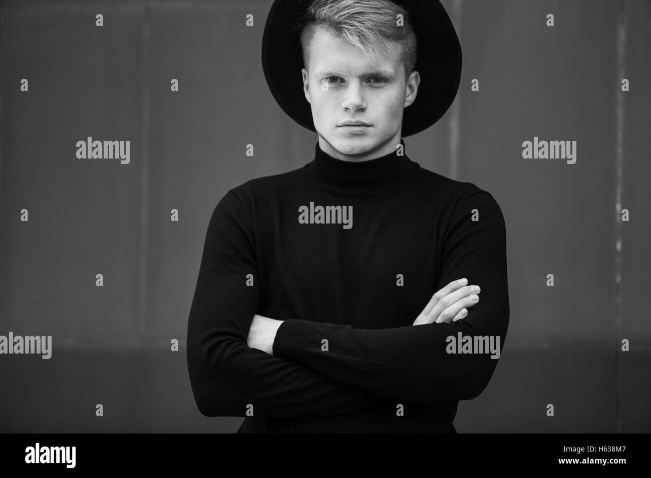 Young man posing with a trendy outfit against urban background Stock ...