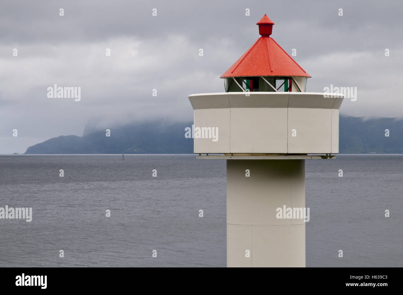Ulvesund lighthouse ('fyr') and Silda island in the background, near Måløy, western Norway. Stock Photo
