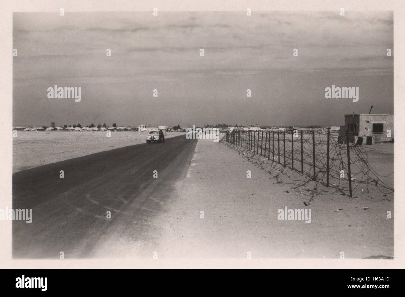Road outside a British army base in Egypt in the period prior to withdrawal of British troops from the Suez Canal zone and the Suez Crisis. Location 10 Base Ordnance Depot Royal Army Ordnance Corps (RAOC) camp at Geneifa Ismailia area near the Suez Canal 1952 Stock Photo