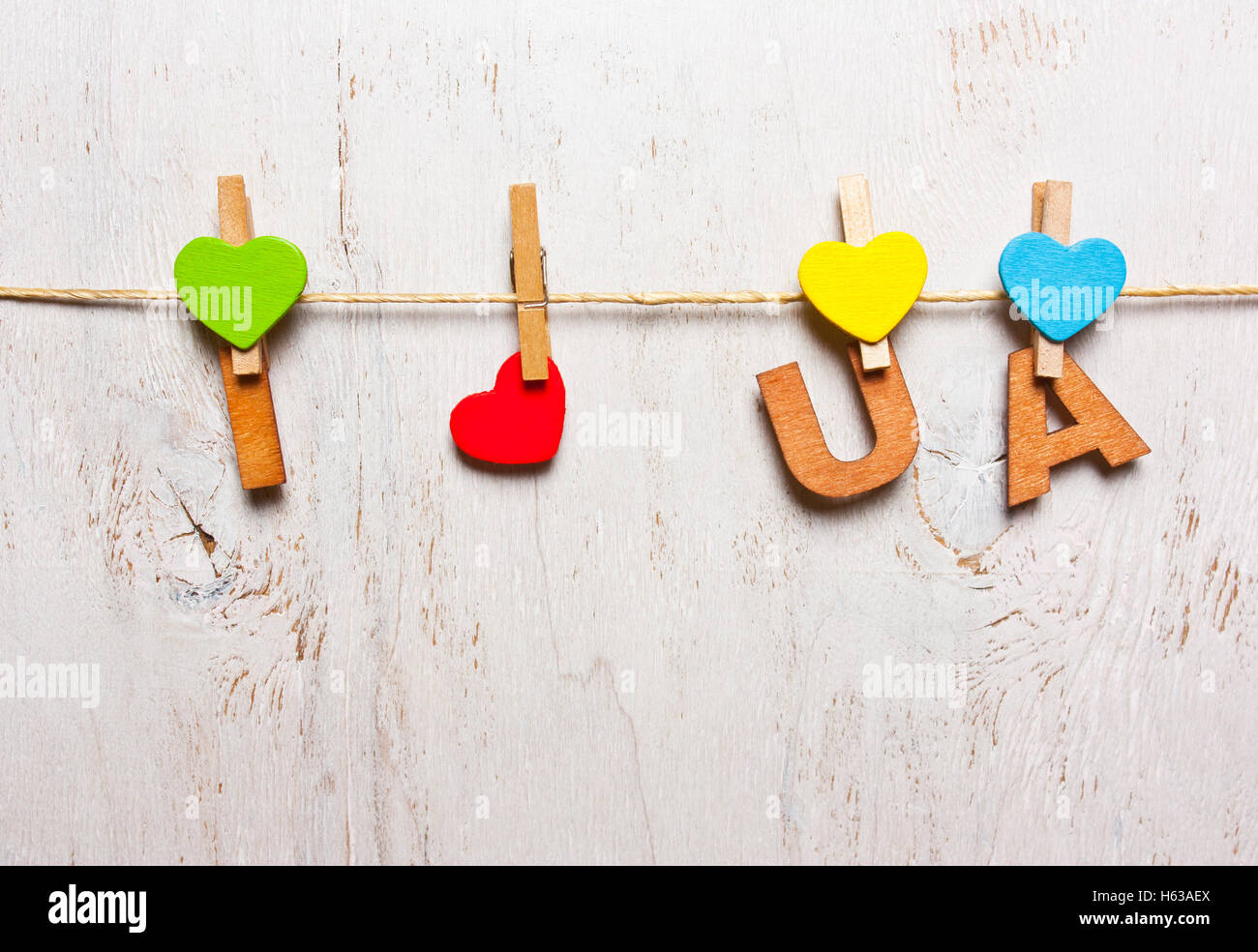 the word 'i love UA' from the wooden letters on a clothespin on a white background old Stock Photo