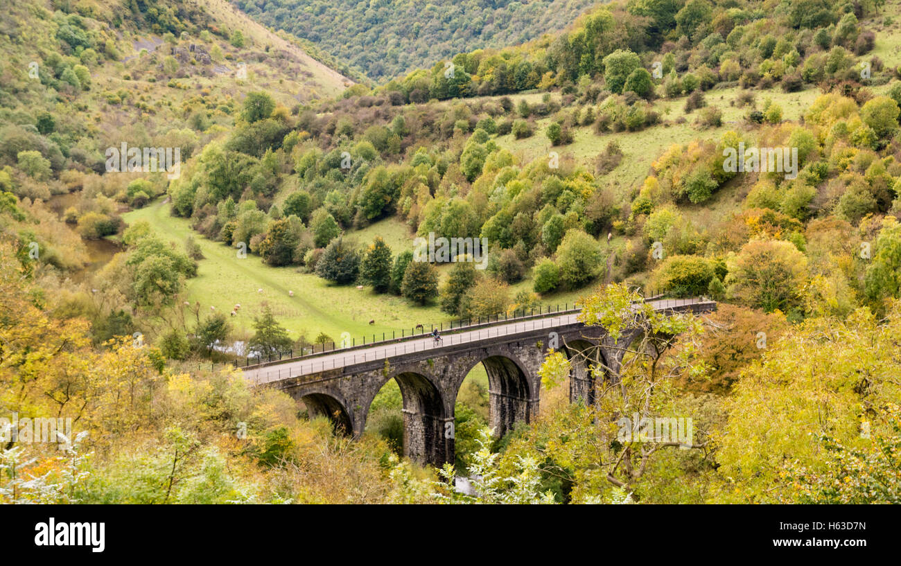 Looking down on the viaduct at Monsal Head in the Derbyshire Peak District, UK, with a cyclist riding across. Stock Photo