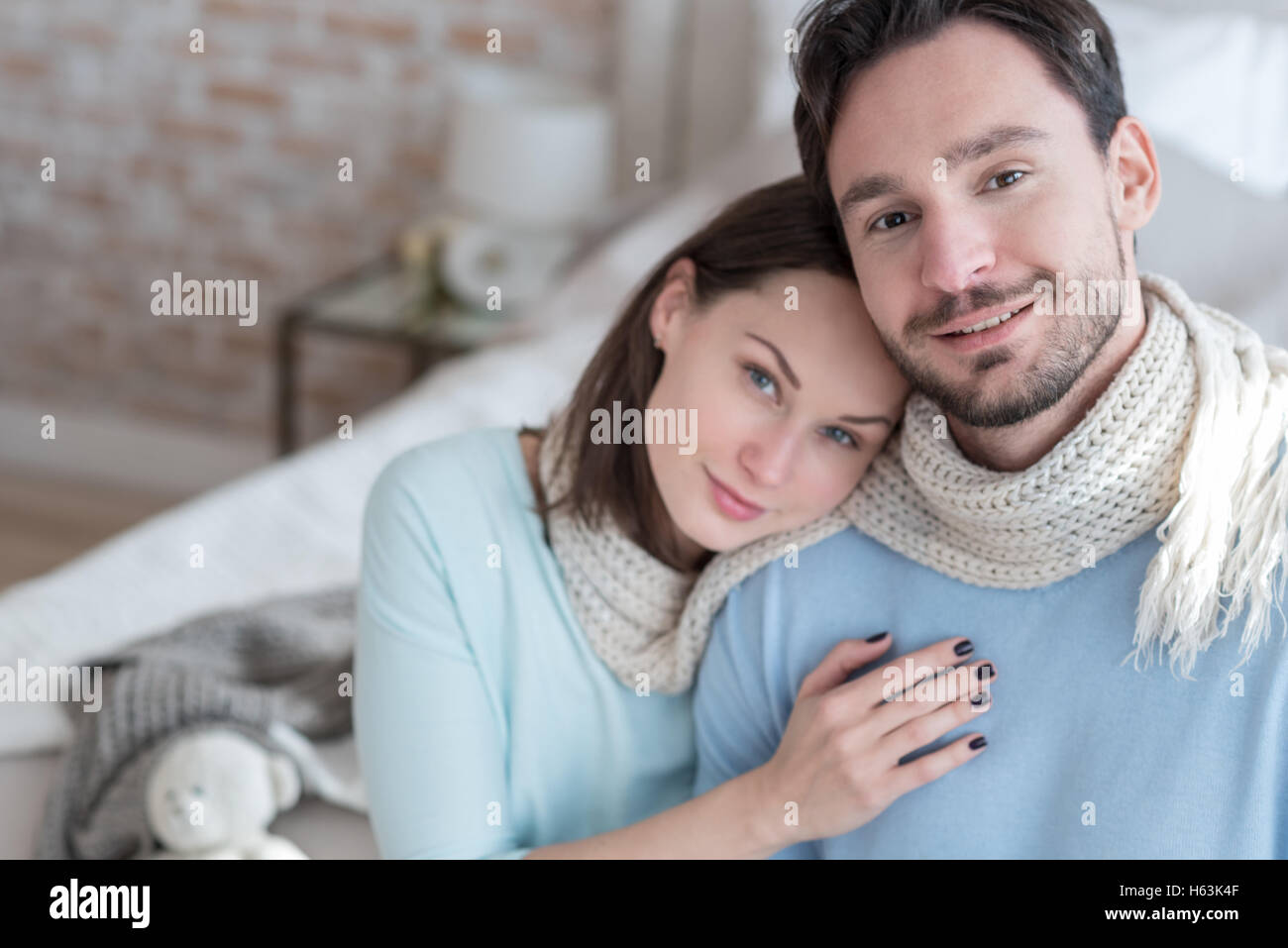 Happy delighted man sitting near his girlfriend Stock Photo