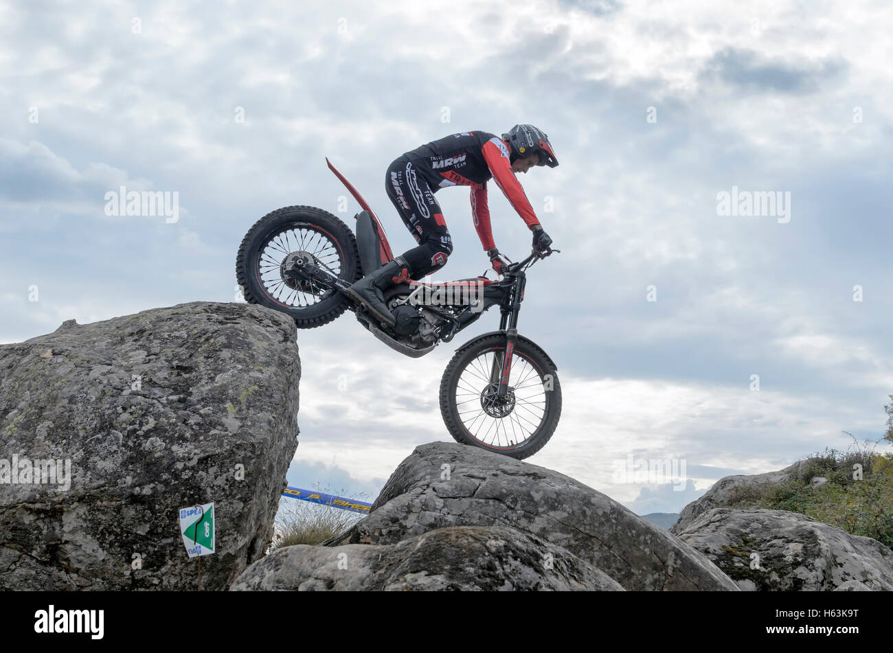 Motorcycling. Trial race. Spain championship. Oriol Noguera overtaking an obstacle, over big granite stones, in Valdemanco Stock Photo