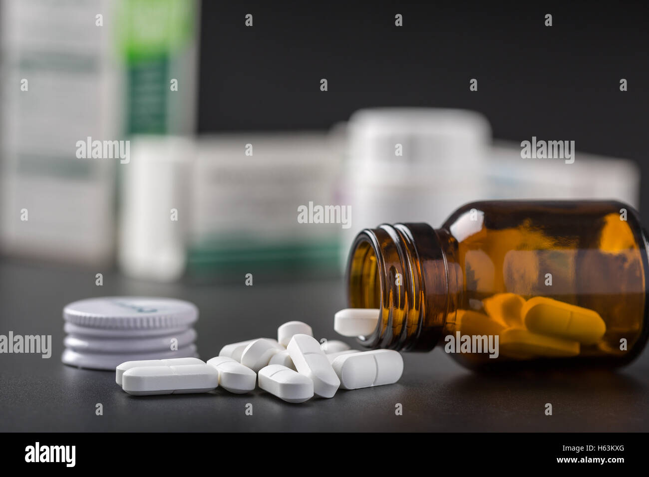 White pills and brown glass pill bottle Stock Photo