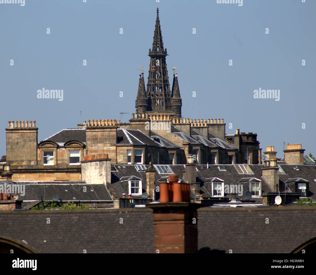 Glasgow University clock tower lording it over the rooftops and chimney pots of Glasgow Stock Photo