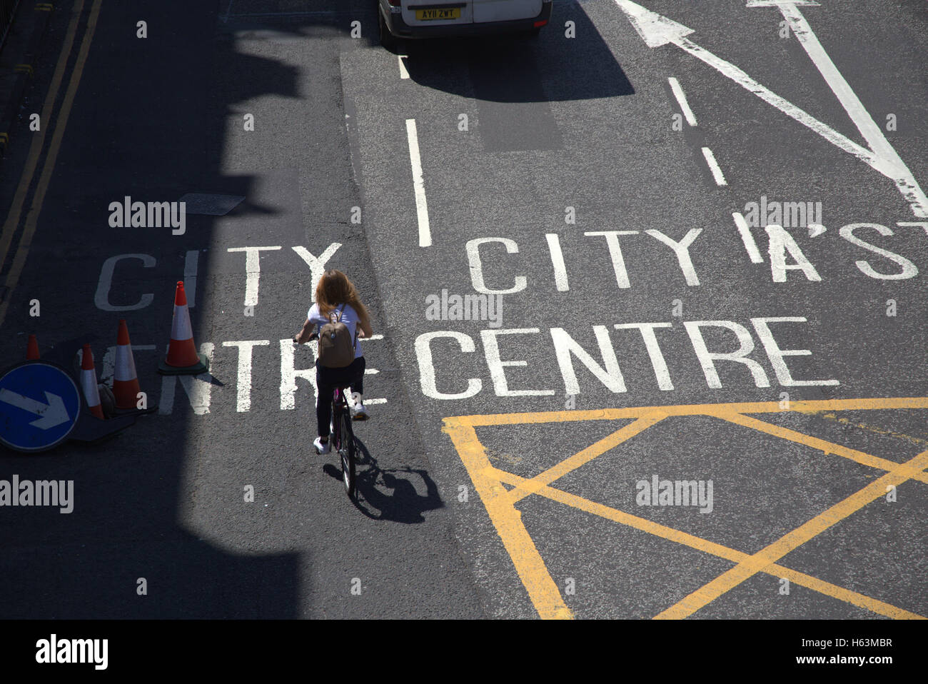 girl on road bicycle bike city centre markings Glasgow, Scotland Stock Photo