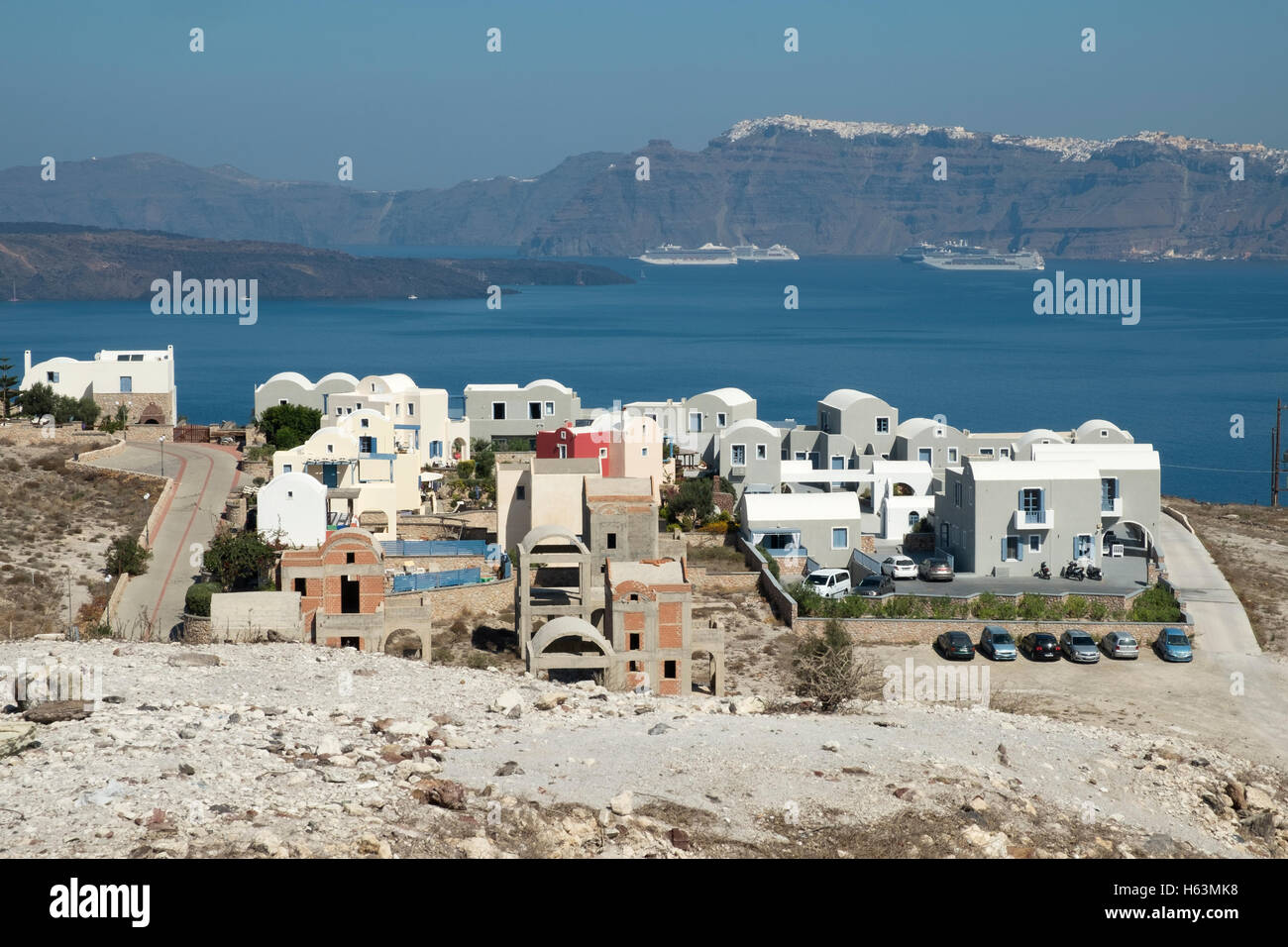 New houses under construction at Akrotiri on the island of Santorini, Greece with the caldera and Thira in the background. Stock Photo