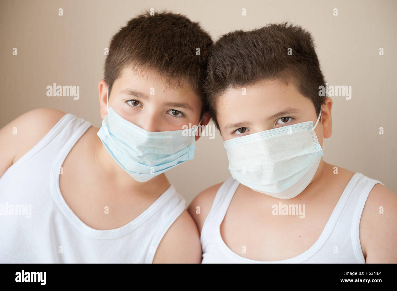two handsome boys in medical masks looking in camera Stock Photo Alamy