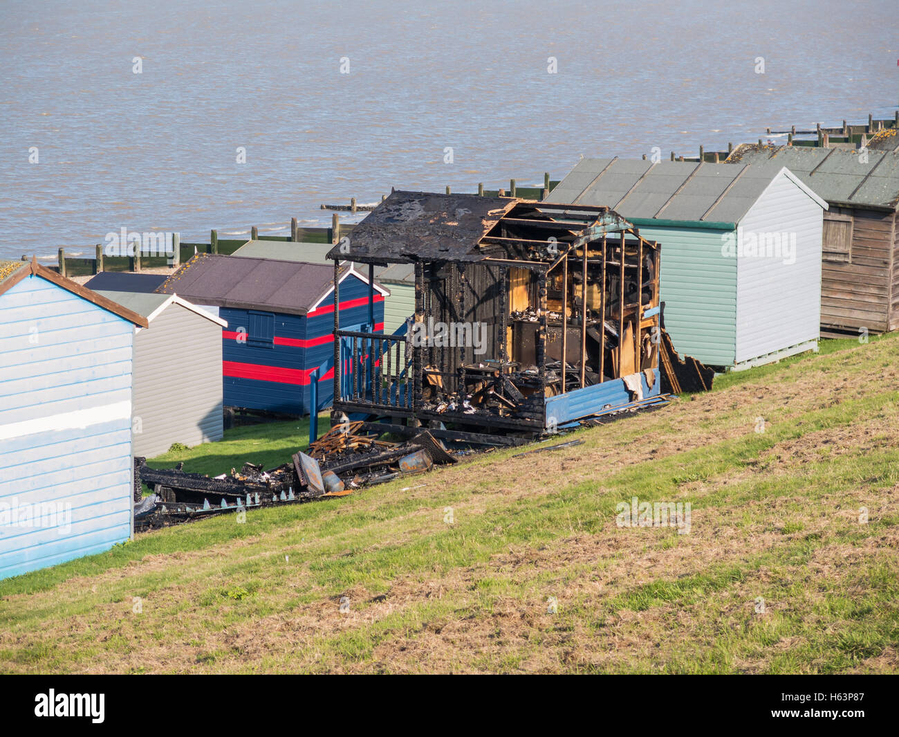 WHITSTABLE, UK - OCT 23 2016.  Two beach huts burnt out along Tankerton seafront, Whitstable. Local press report that arson is t Stock Photo