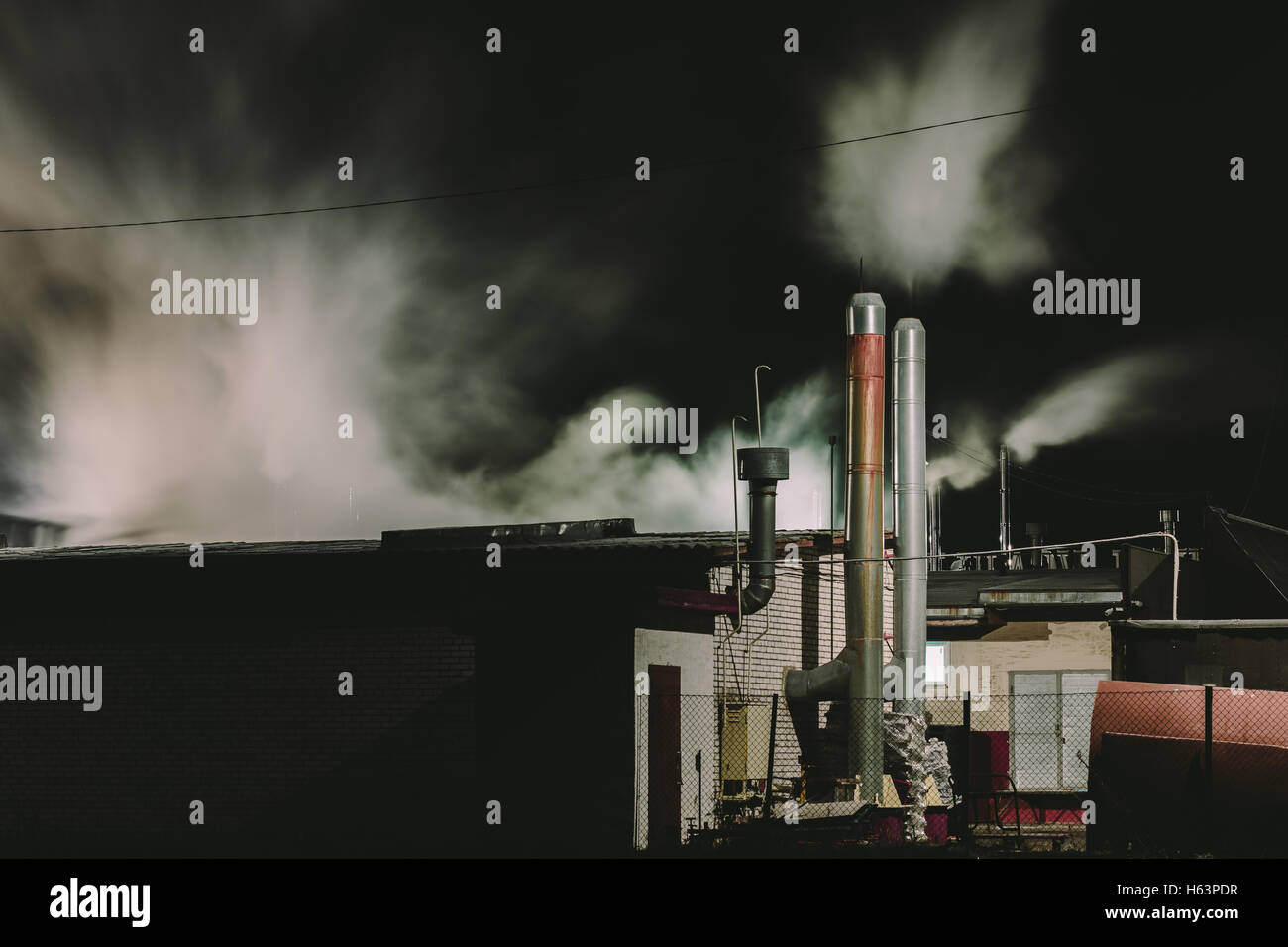 pipe factory emits smoke Stock Photo