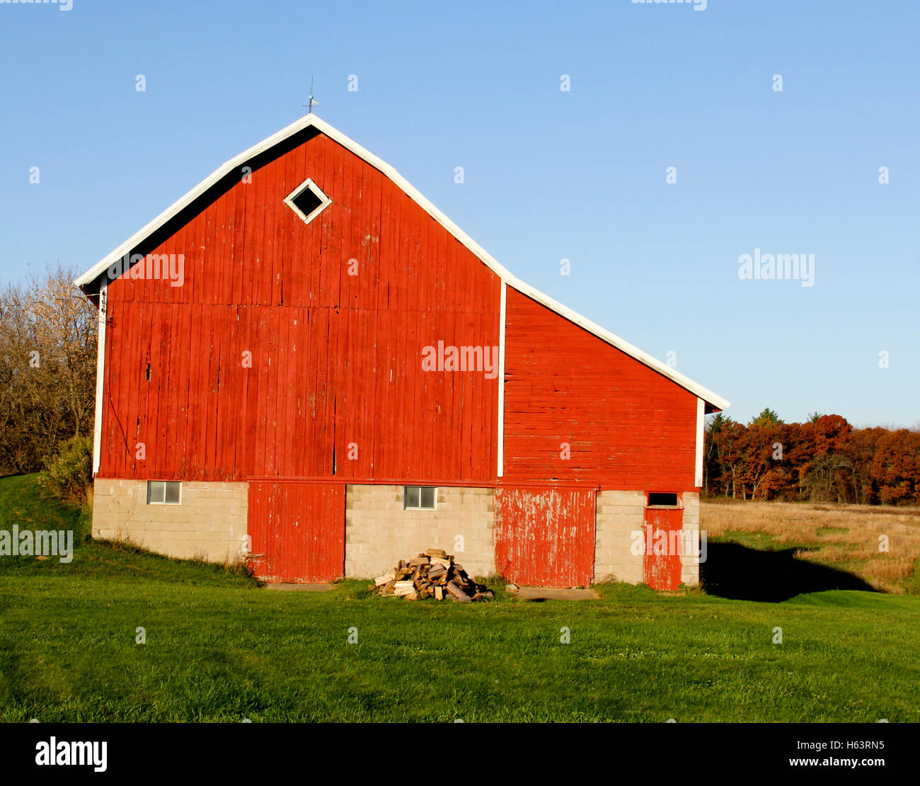 shot in the late afternoon shadows of Autumn. OLD RED BARN on a Family Farm In Central Wisconsin