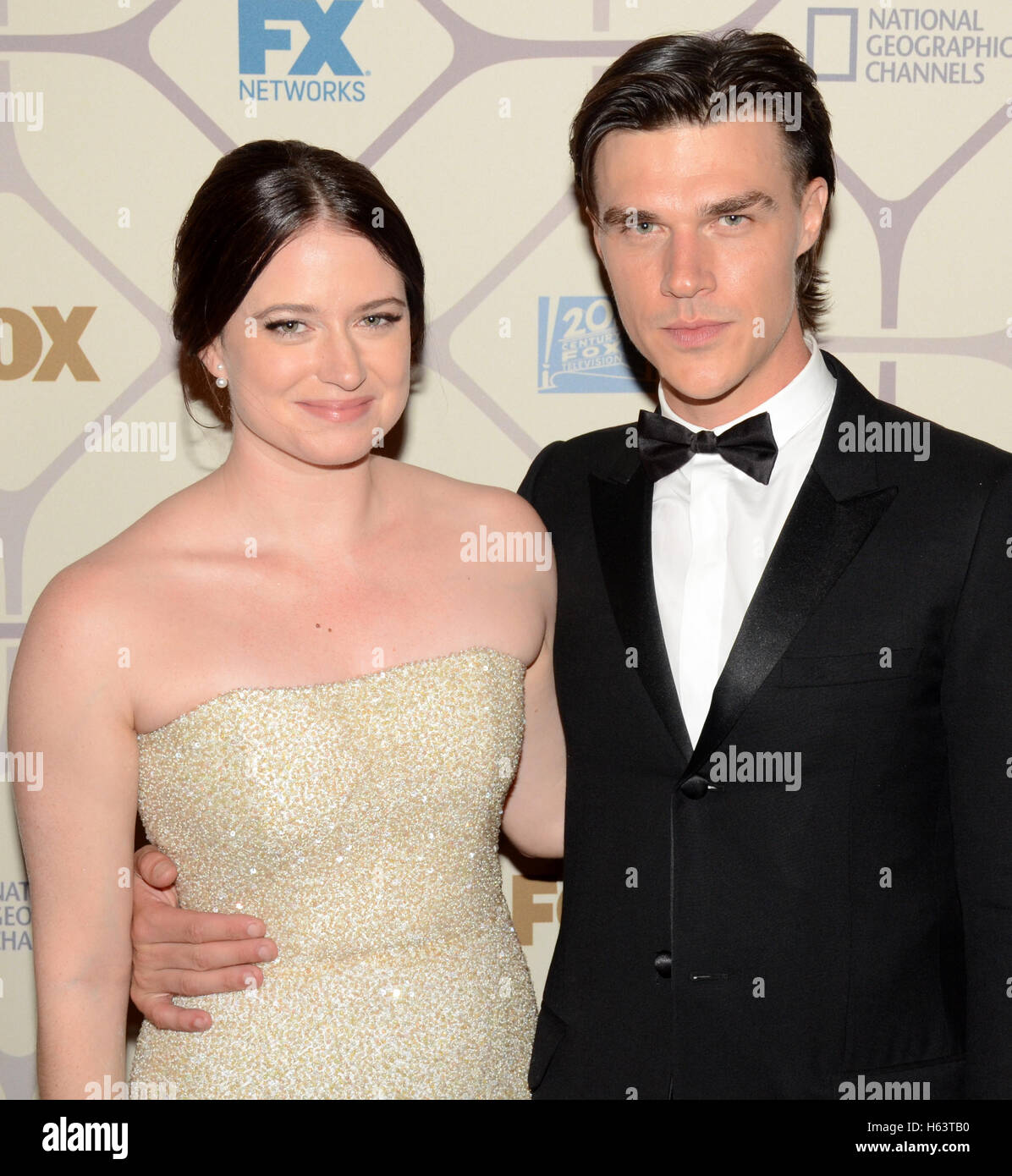 Actor Finn Wittrock (r) and Sarah Roberts attend the 67th Primetime Emmy Awards Fox after party on September 20, 2015 in Los Angeles, California. Stock Photo