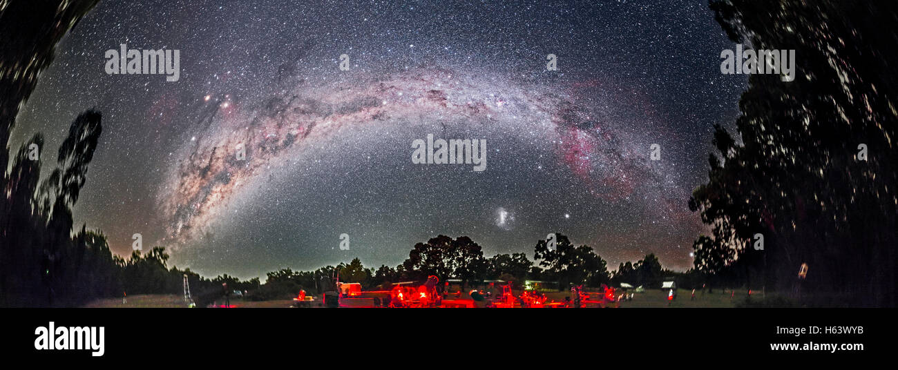 The spectacular southern Milky Way arching over the OzSky 2016 star party near Coonabarabran, NSW, Australia, in a roughly 240° Stock Photo