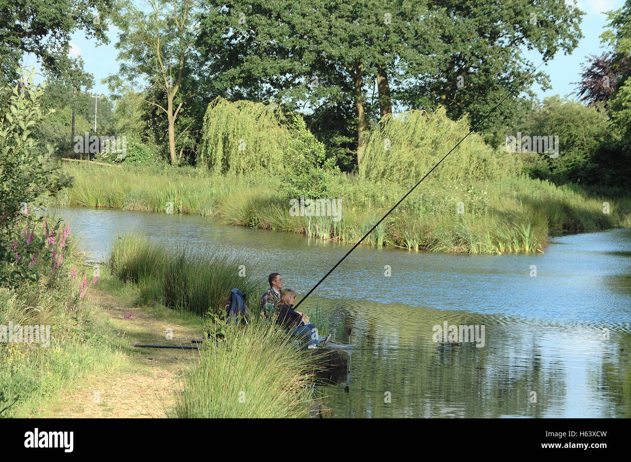 Couple carp fishing in Stoneham lakes, Eastleigh, Hampshire Stock Photo