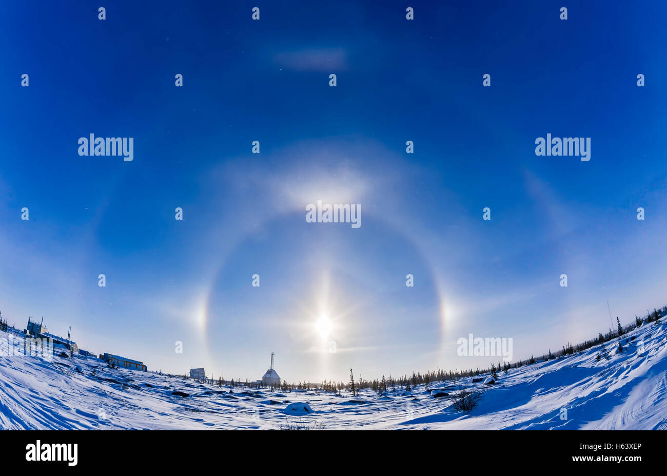 A display of ice crystal haloes over the Churchill Rocket Range, Feb. 9, 2016. The Sun is surrounded by the main 22° halo with e Stock Photo