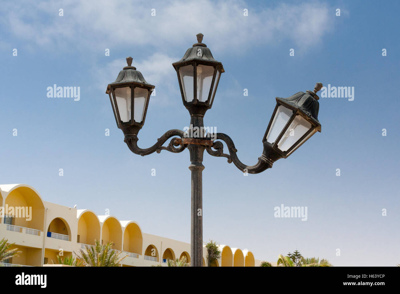 3 lamp lamp post with one lamp bent Stock Photo