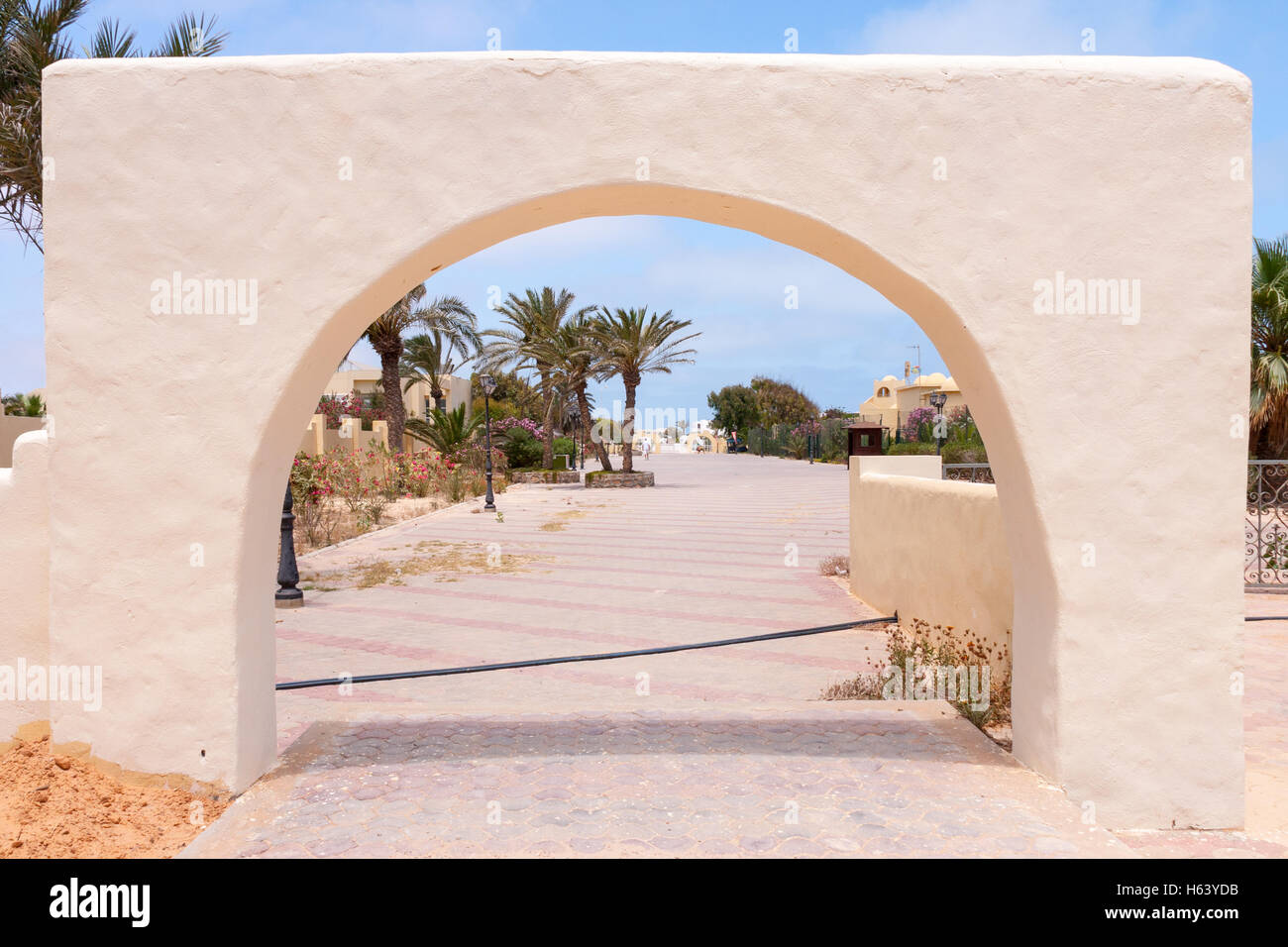 freestanding stone archway on road outside Penelope Beach Imperial Hotel, Djerba, Tunisia Stock Photo