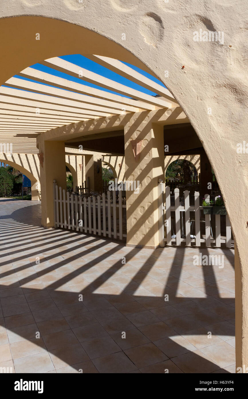 veranda in sunshine casting shadows below Stock Photo