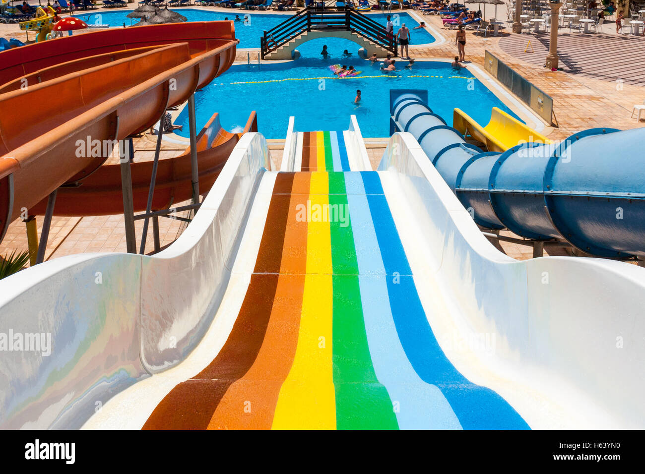 rainbow coloured water slide in water park Stock Photo Alamy