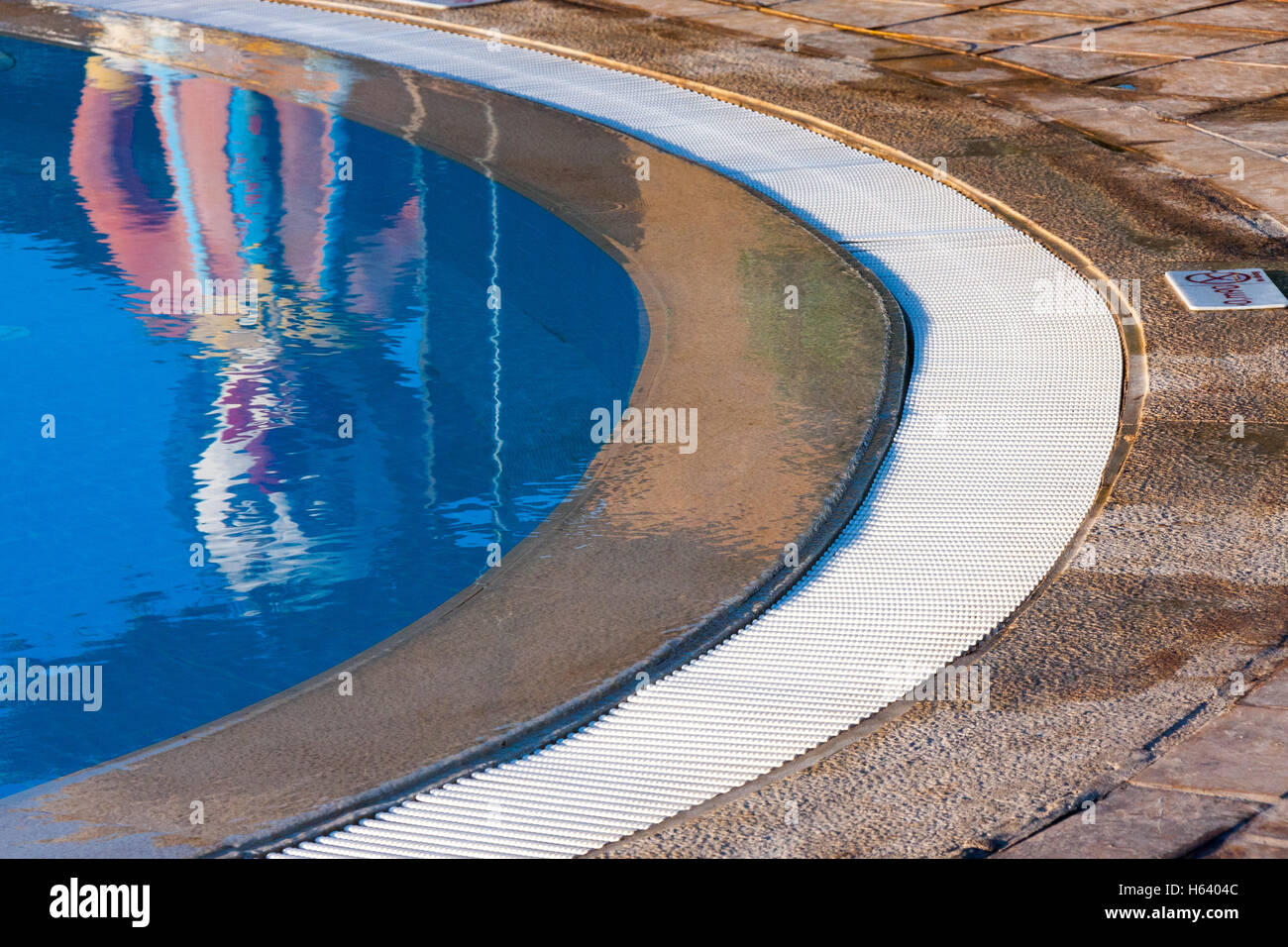 clown statue reflection in swimming pool Stock Photo