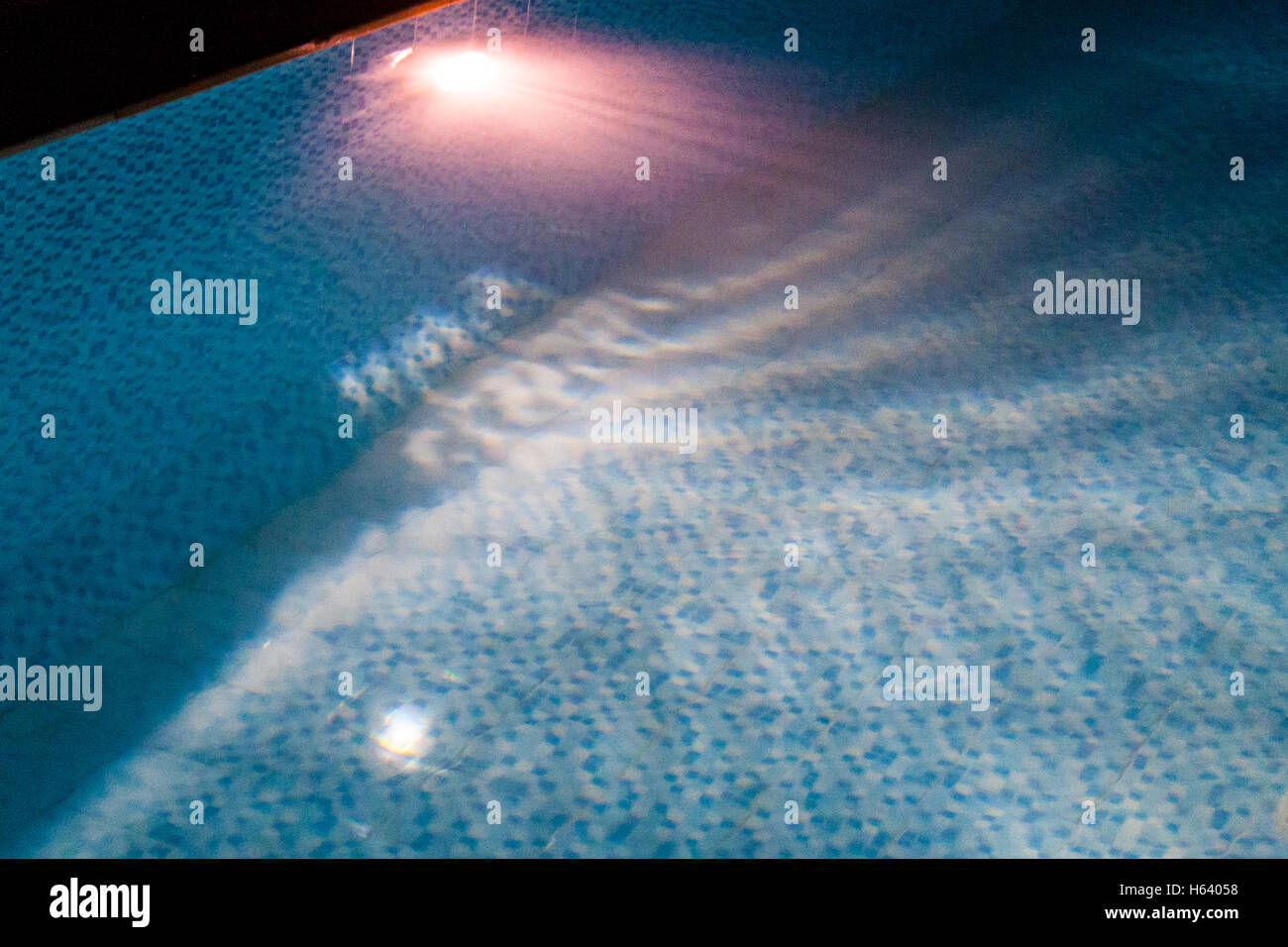 swimming pool lit at night close up Stock Photo - Alamy