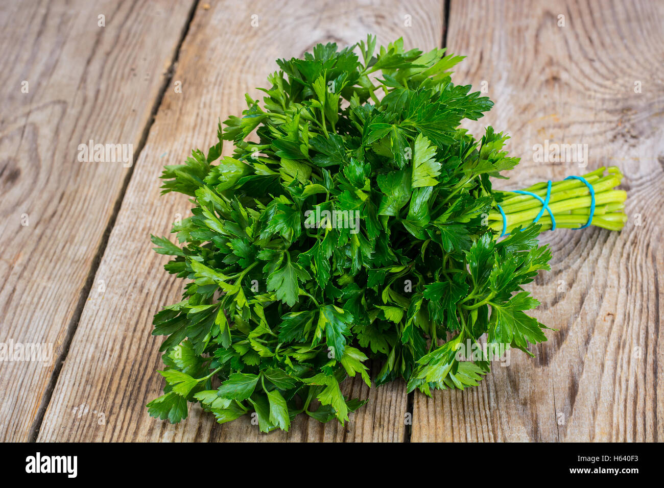 Fresh green bunch of parsley on the old board Stock Photo
