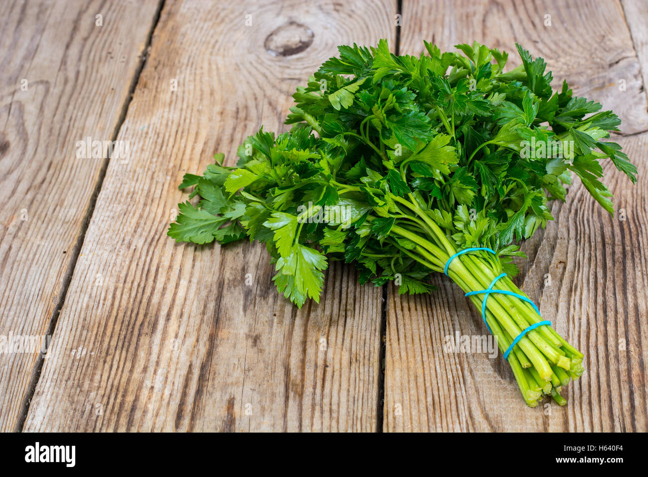 Fresh green bunch of parsley on the old board Stock Photo