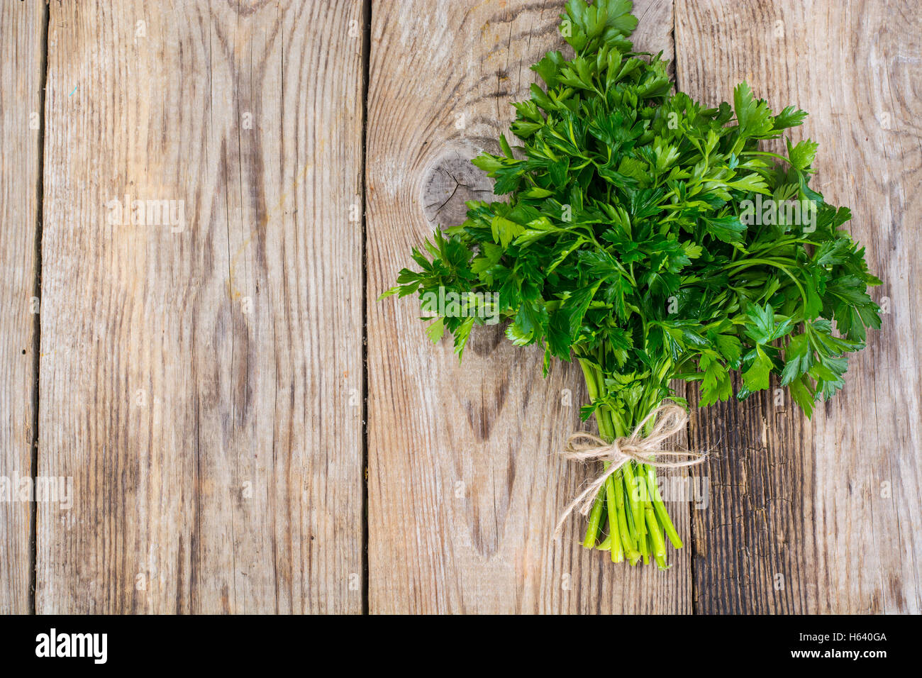 Fresh green bunch of parsley on the old board Stock Photo