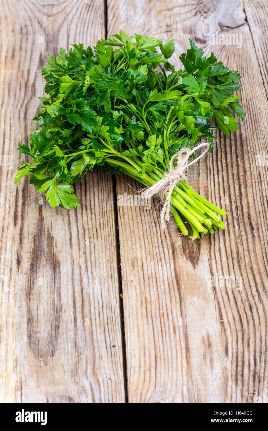 Fresh green bunch of parsley on the old board Stock Photo