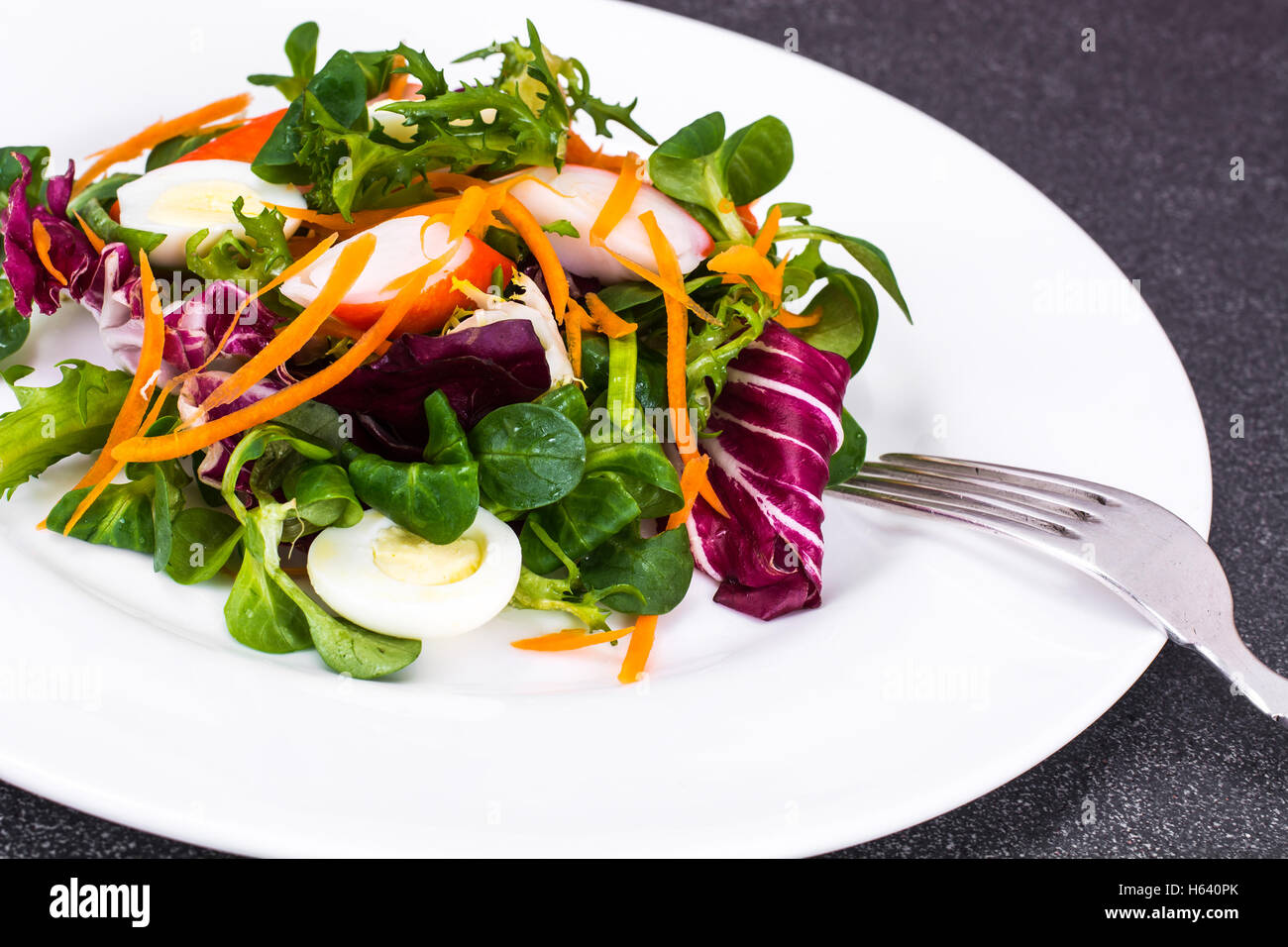 Frise Corn Salad with Chicory, Escarole, Crab Sticks and Quail E Stock Photo