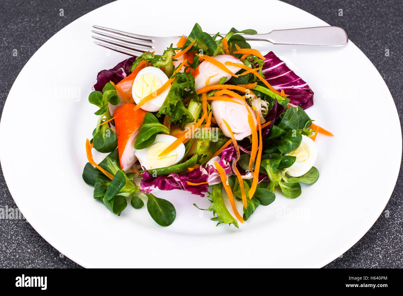 Frise Corn Salad with Chicory, Escarole, Crab Sticks and Quail E Stock Photo