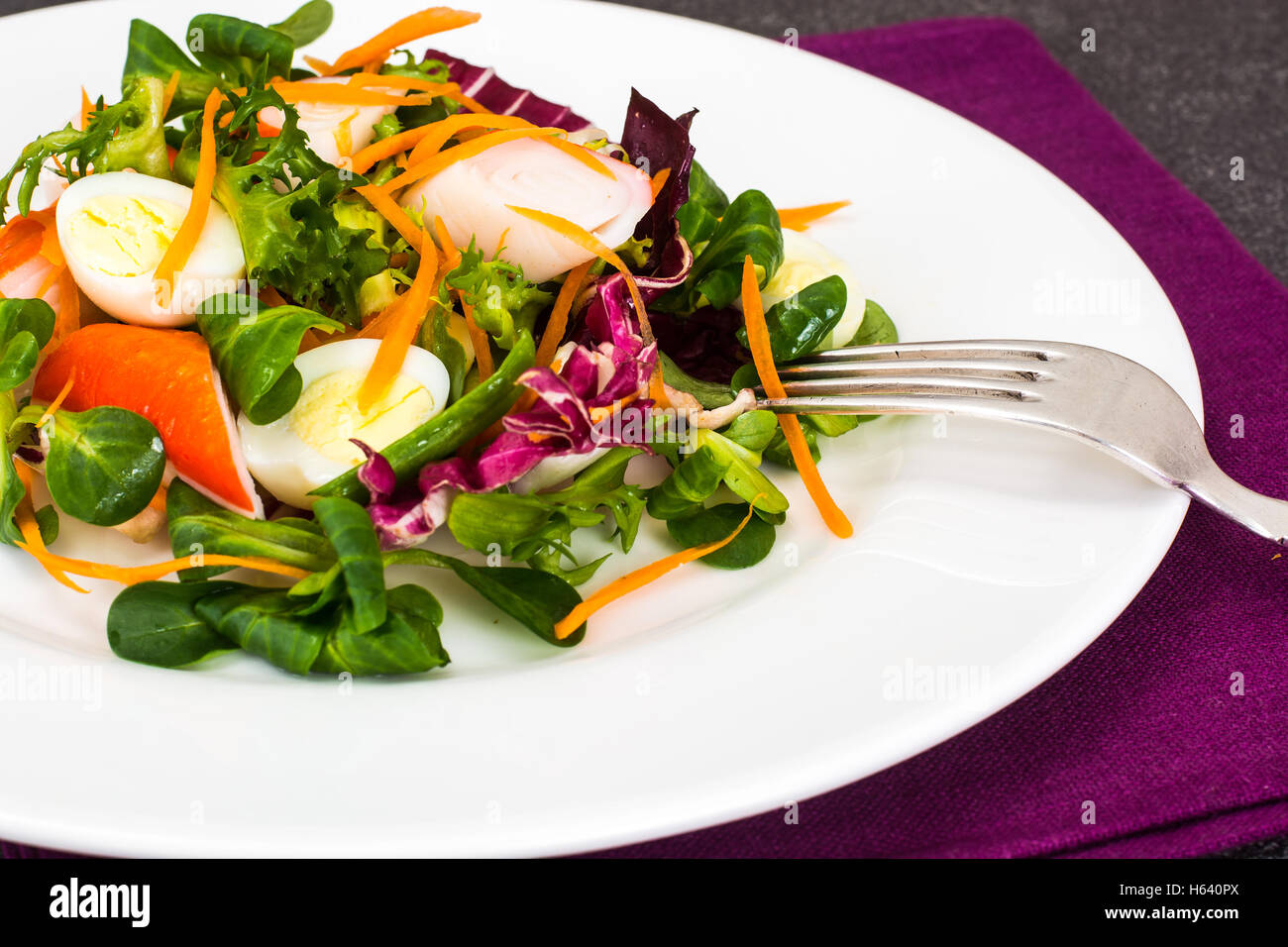 Frise Corn Salad with Chicory, Escarole, Crab Sticks and Quail E Stock Photo